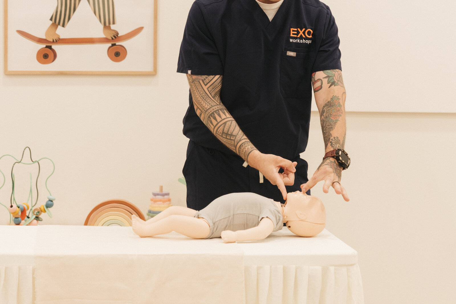 Close-up of an EXO instructor demonstrating infant chest compressions